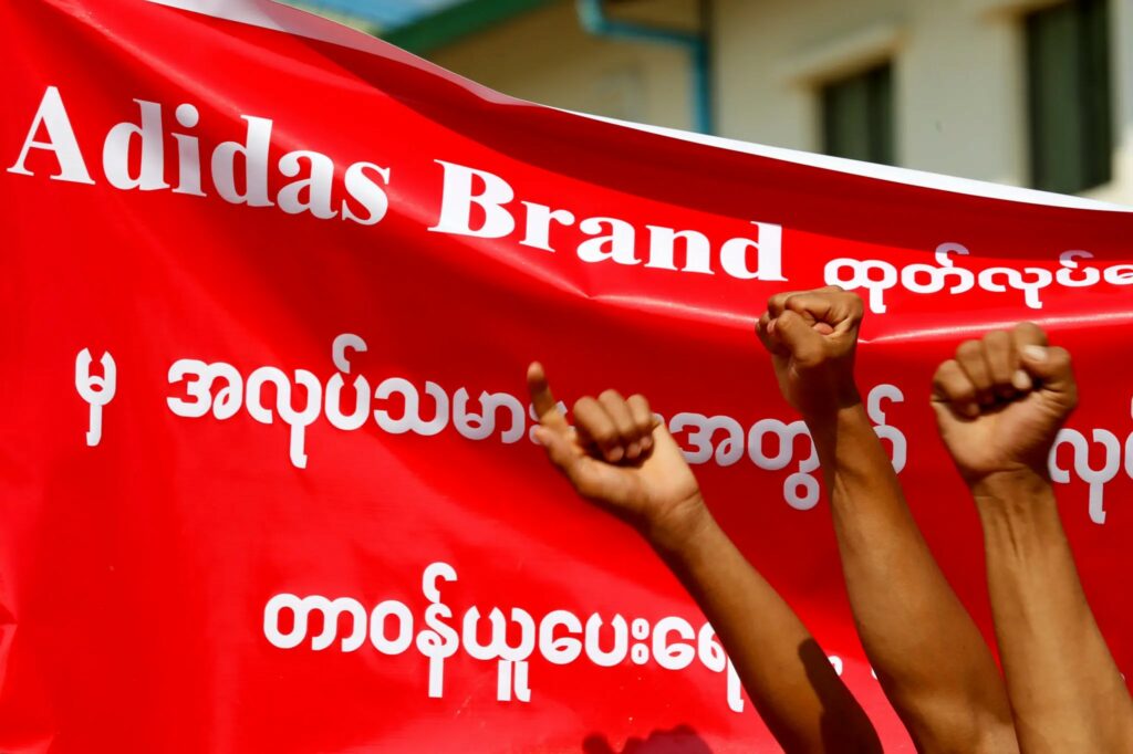 A banner at a protest in Yangon in 2019 called for Adidas to take responsibility for labor rights