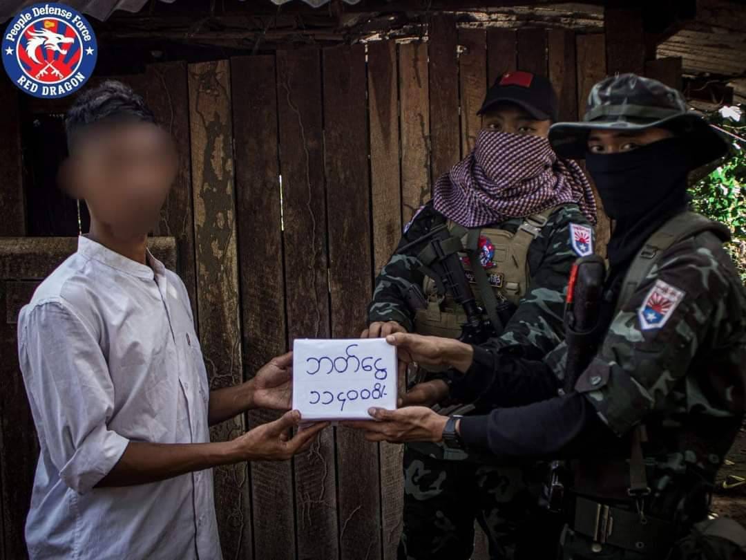 (​သေနတ် ၂ လက်ဖြင့်CDMပြုလုပ်​​သောစစ်သားကို နဂါးနီစစ်​ကြောင်းတပ်ခွဲ (၂) ကNUGကိုယ်စားဂုဏ်ပြု​ငွေ​ပေးအပ်စဥ်။ ဓါတ်ပုံ-နဂါနီစစ်​ကြောင်း)