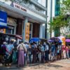 (စစ်တပ်အာဏာသိမ်းလိုက်သဖြင့် CDM မလုပ်ဘဲစစ်​ကောင်စီလက်​အောက်ဖွင့်​သောဘဏ်များကို ပြည်သူများက သပိတ်​မှောသည့်အ​နေဖြသ့်ဘဏ်တွင်​အပ်ထား​သော​ငွေများပြန်ထုတ်ကြရာမှ ဘဏ်များအကျပ်အတည်းဆိုက်ခဲ့ပြီး​ ​ စစ်​ကောင်စီကငွေသားထုတ်​ပေးမှုကိုကန့်သတ်ခဲ့သည်။ထို့သို့ကန့်သတ်သဖြင့်ဘဏ်များအ​ပေါ် ပြည်သူများမယုံကြည်​မှုတိုးလာပြီး ဘဏ်တွင်အပ်ထား​သောမိမိတို့၏ငွေများကို အလုအယက်ပြန်ထုတ်ယူရန် ၂၀၂၁ ​မေလက ကြိုးစား​နေကြစဥ်။ဓါတ်ပုံ-The New York Times)