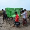 (​မုန်တိုင်း​ကြောင့်သေဆုံးခဲ့​သူများရုပ်အ​လောင်းများကို သဂြိုဟ်ရန် သယ်ယူ​နေကြစဥ်။ဓါတ်ပုံ-Getty images)
