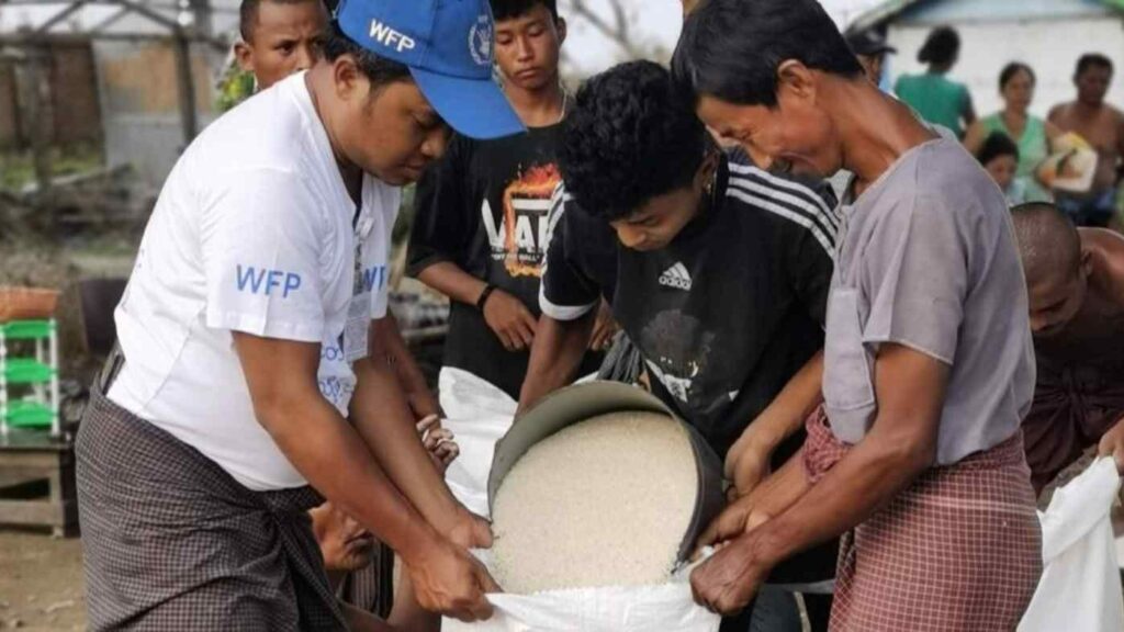 (မုန်တိုင်း​ကြောင့်​နေအိမ်များပျက်စီးသွားသဖြင့် ပြန်​ဆောက်​နေ​သောပြည်သူများနှင့် WFP ကမုန်တိုင်းသင့်ပြည်သူအချို့ကို စားနပ်ရိက္ခာ​ပေးအက်​နေစဥ်။ဓါတ်ပုံ-UN)