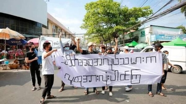 (ရန်ကုန်မြို့၊ ဗဟန်းမြို့နယ်၌ စမ်းချောင်းပင်မသပိတ်စစ်ကြောင်းမှဦးဆောင်ကာ Revolution Force ( RF)၊ LGBT community Yangon တို့မှ လူငယ်များ ပူးပေါင်းပါဝင်၍ ၂၀၂၂ မတ်လ ၂၀ ရက်က "သပိတ်ကအစ အလုပ်သမားက လူထုအားလုံးပါဝင်ကြ"စာတန်း ကိုင်ဆောင်ပြီး ဆန္ဒပြနေစဉ်။ ဓာတ်ပုံ - AAMIJ)