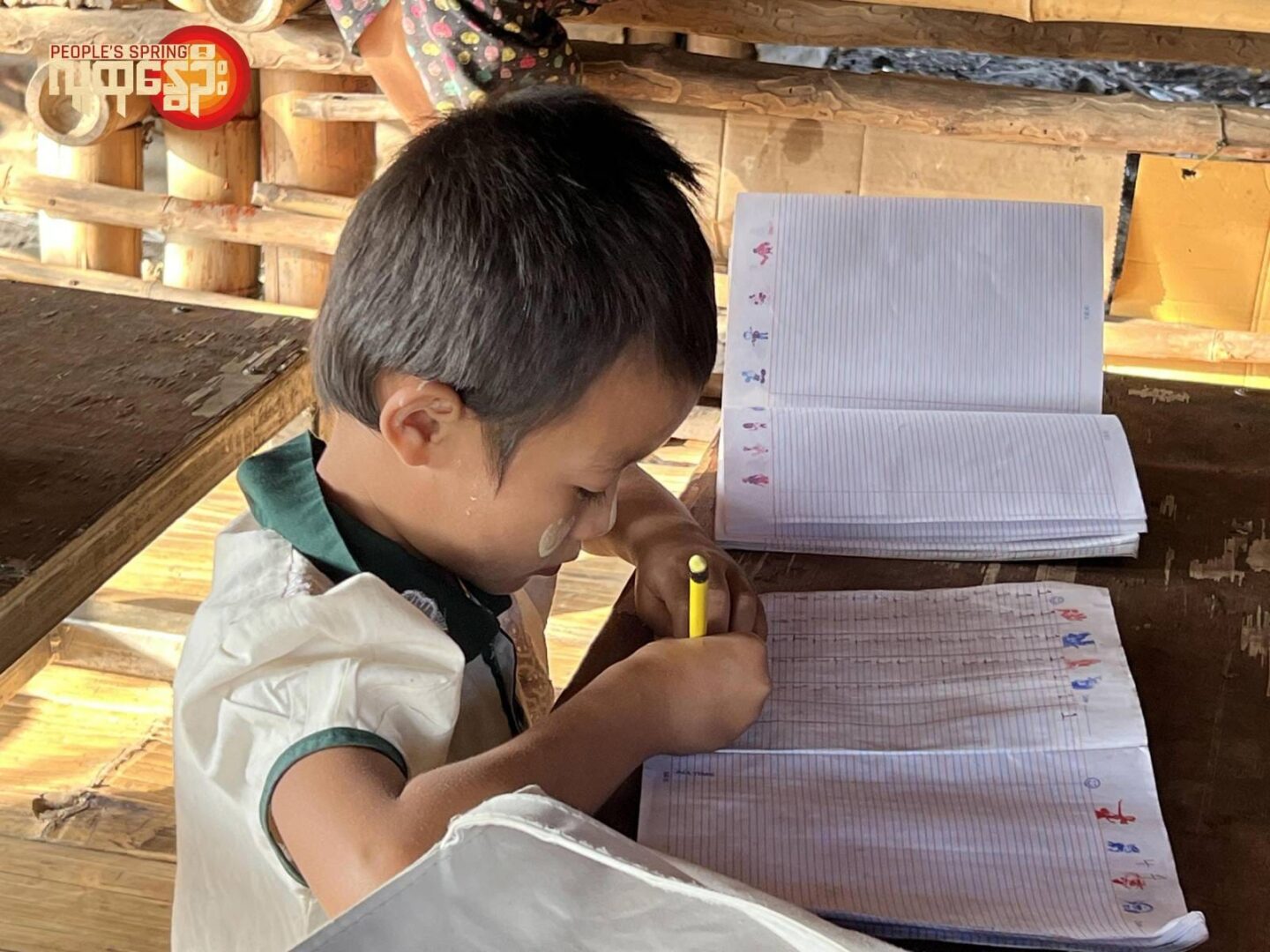 (မဲဆောက်မြို့က ငါတို့စာသင်ကျောင်း တည်ထောင်ပြီးစာသင်စာသင်ကြားပေးနေတဲ့ဆရာမအနော်နဲ့ ပညာသင်ကြားနေတဲ့စစ်ဘေးရှောင်မြန်မာကလေးငယ်တွေ။ ။ဓါတ်ပုံ-လက်သွေး)