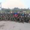 (တူပီမြို့ ခလရ(၃၀၄)တပ်ရင်း ဆိုင်းဘုတ်ရှေ့၌ အောင်ပွဲခံနေသော ယောတပ်တော်(YA) ရဲဘော်များ။ ဓာတ်ပုံ - YA)